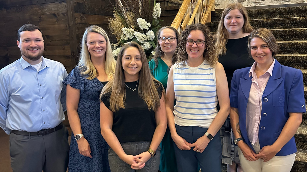 a group of employees pose for a group photo
